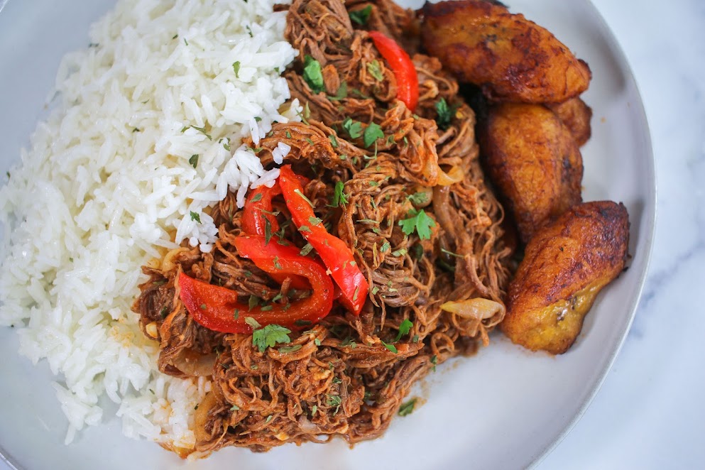 A plate of food with rice and meat.