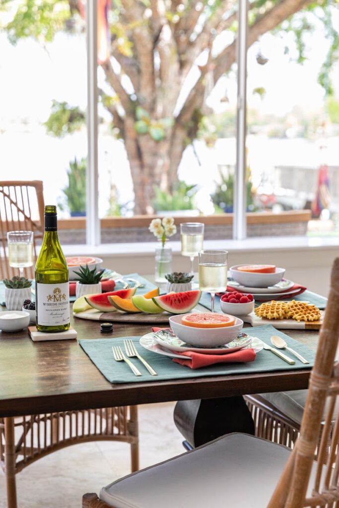 A table with plates and wine glasses on it