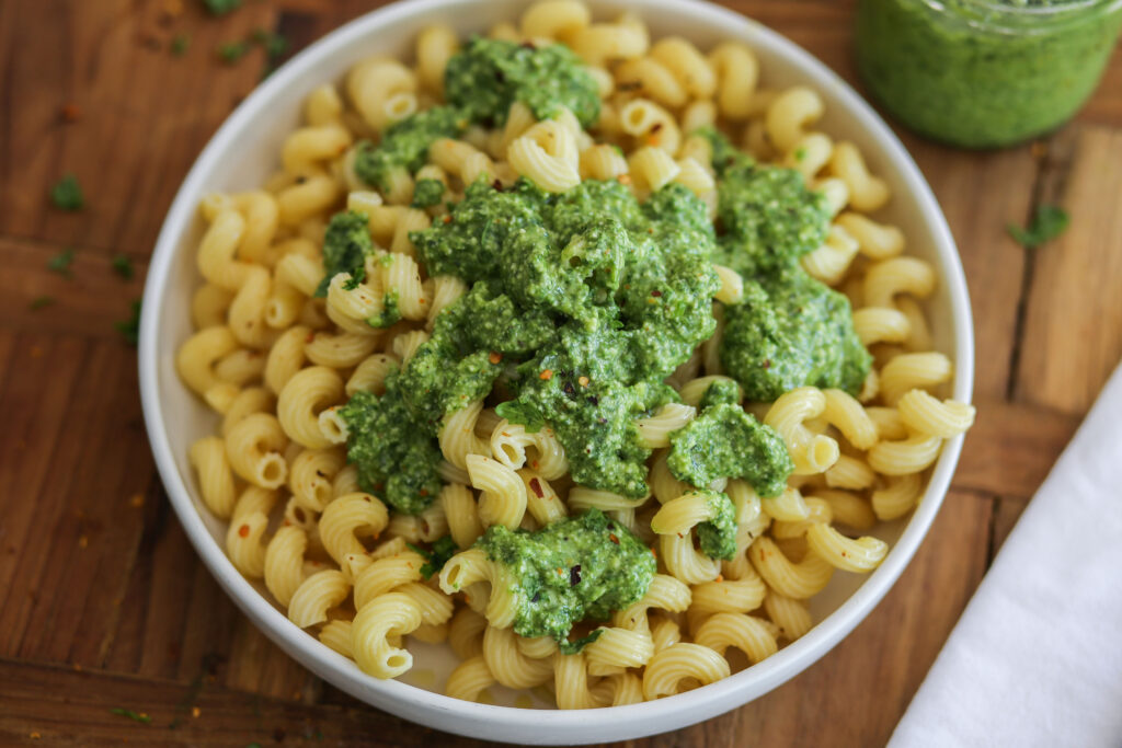 A bowl of macaroni and cheese with broccoli.