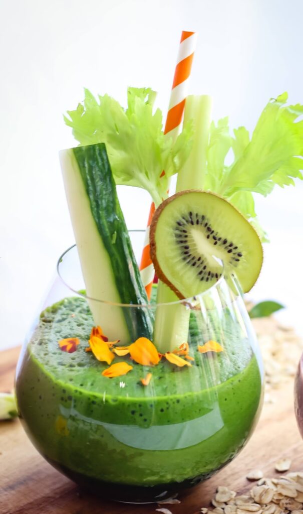 A green smoothie with fruit and vegetables in it.