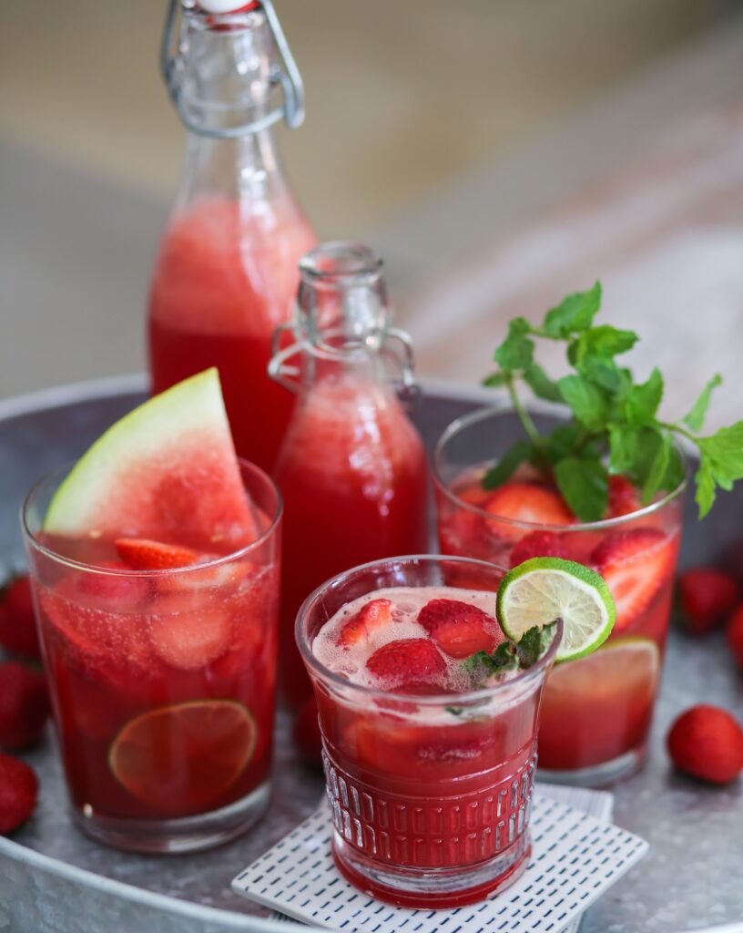 A tray with watermelon and other fruit drinks.