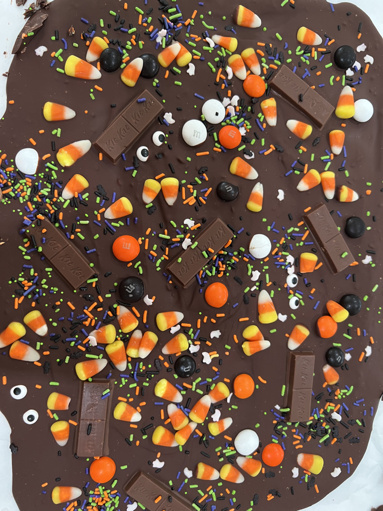 A chocolate covered candy bar with halloween decorations.