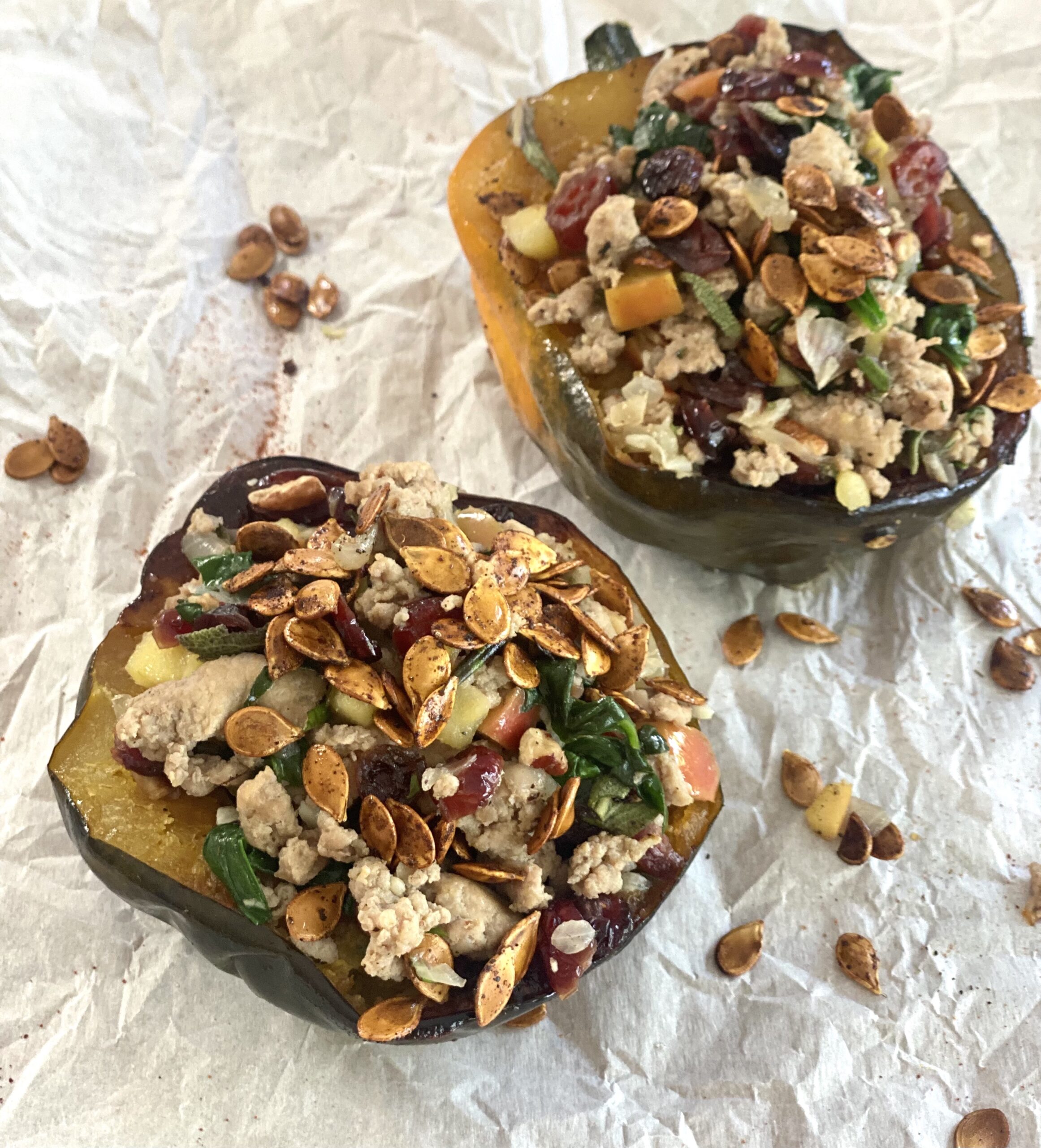 Two stuffed squash halves with nuts and other ingredients.