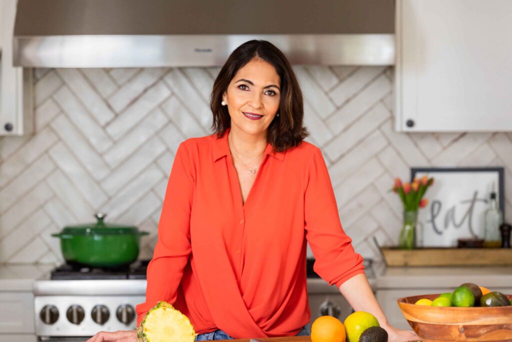 A woman standing in front of some fruits