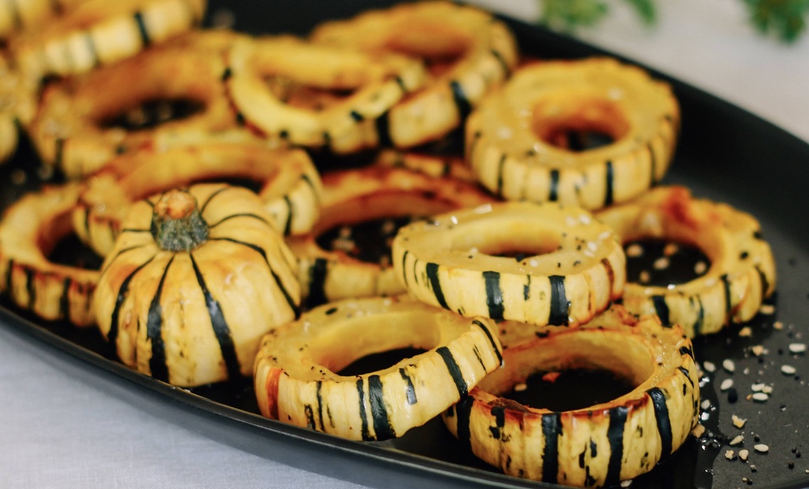 A tray of squash rings with black and brown stripes.