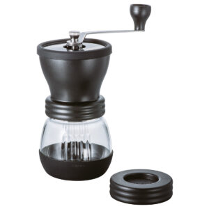 A coffee grinder with the lid open and the top opened.