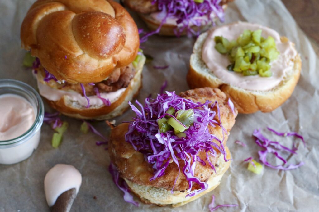 A close up of some sandwiches with purple cabbage