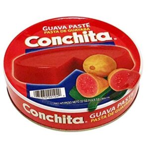 A tin of guava paste with some pieces cut up.
