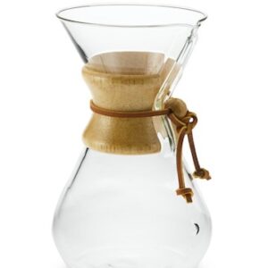 A glass chemex coffee maker with wooden handle.