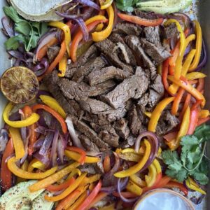 A tray of food with meat and vegetables.