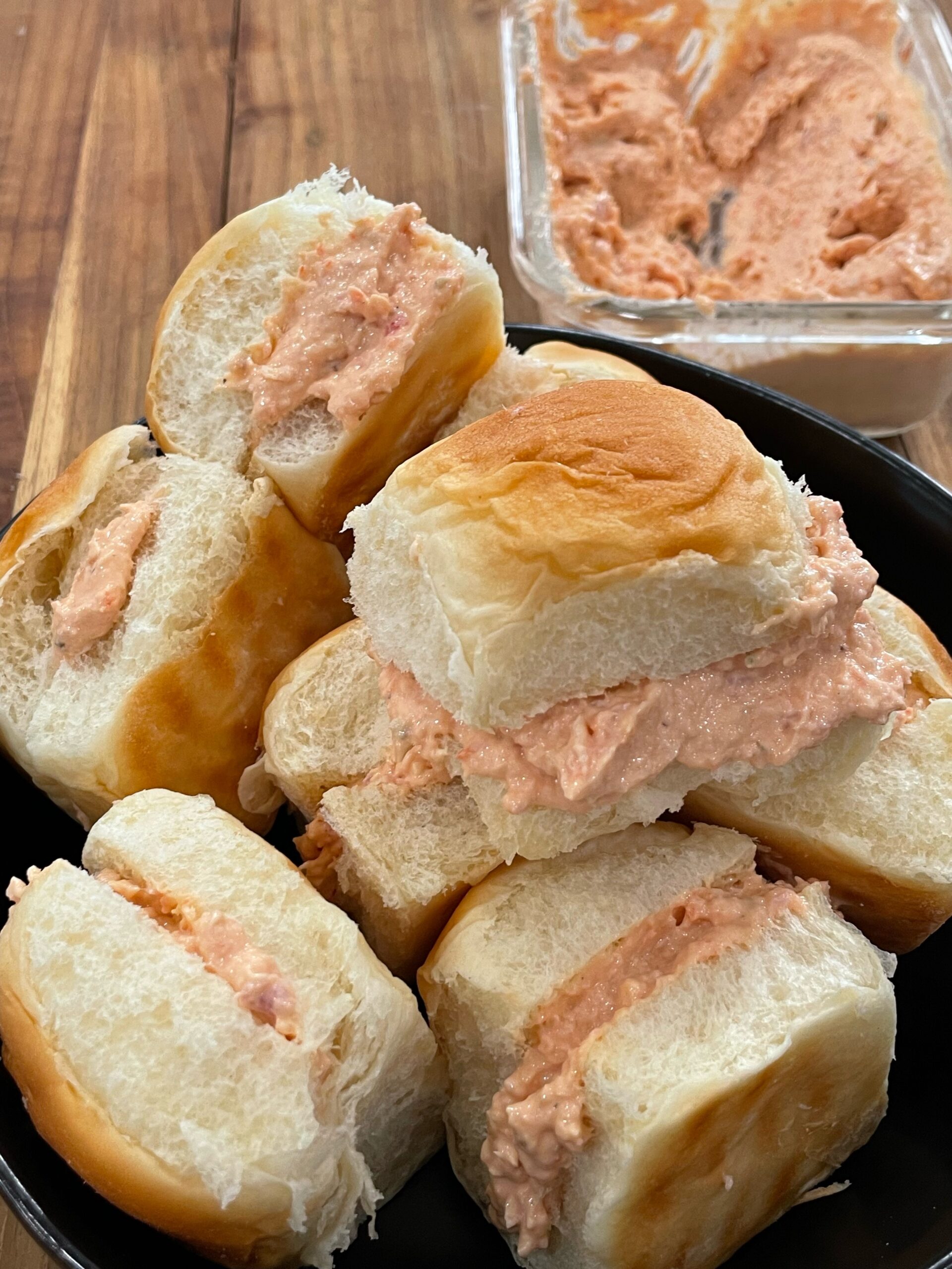 A plate of sandwiches with salmon spread on top.