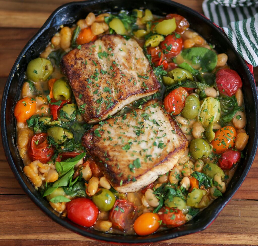 A pan of food with meat and vegetables in it.