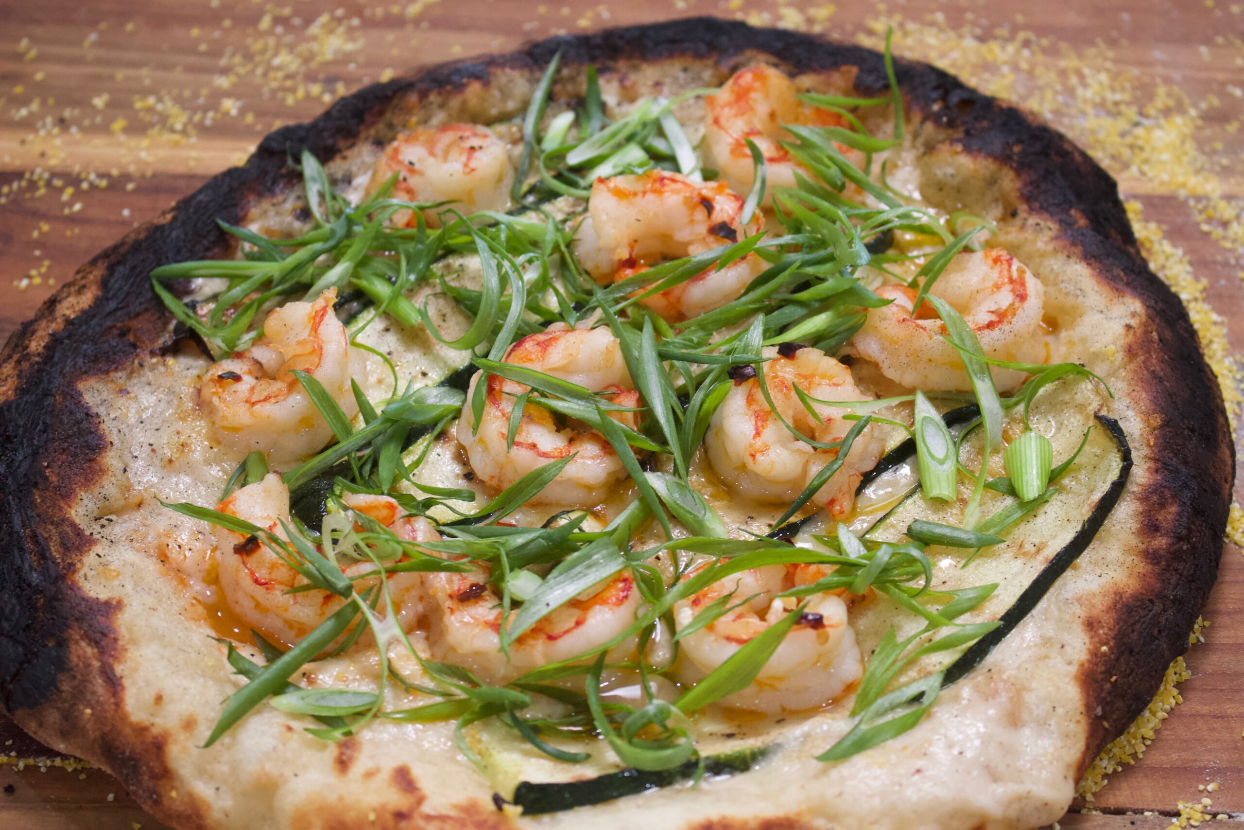 A plate of food with shrimp and green onions.