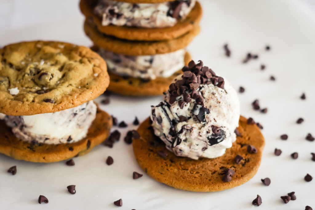 Cookies and ice cream sandwiches on a table.