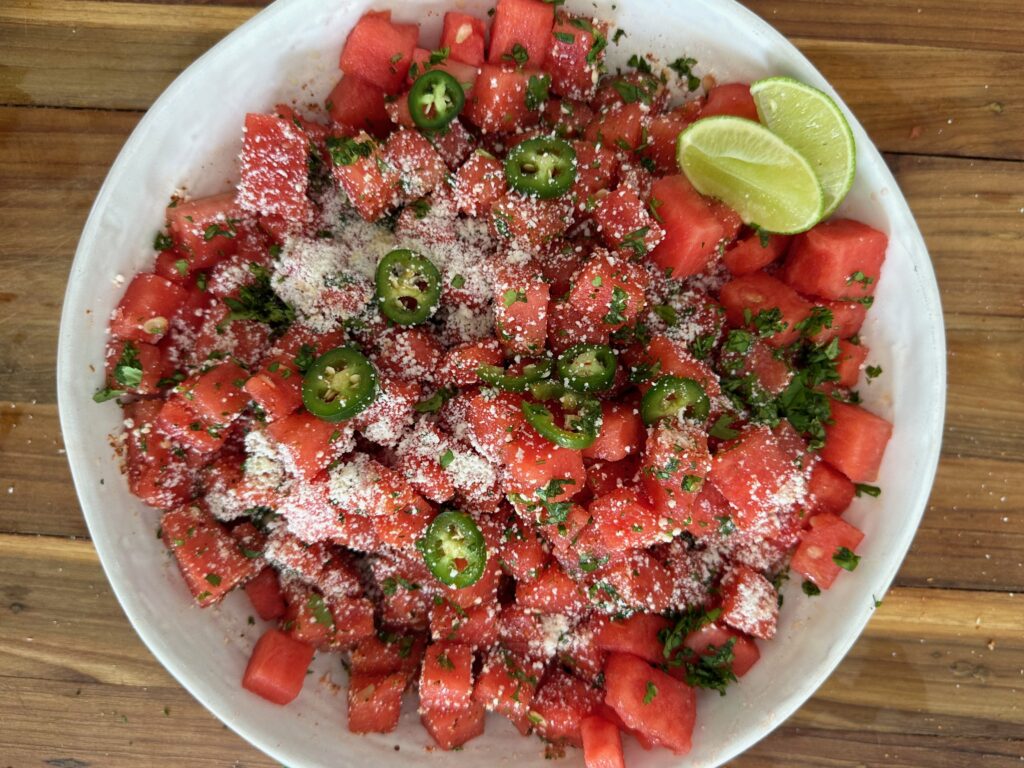 A bowl of watermelon salad with lime and cilantro.