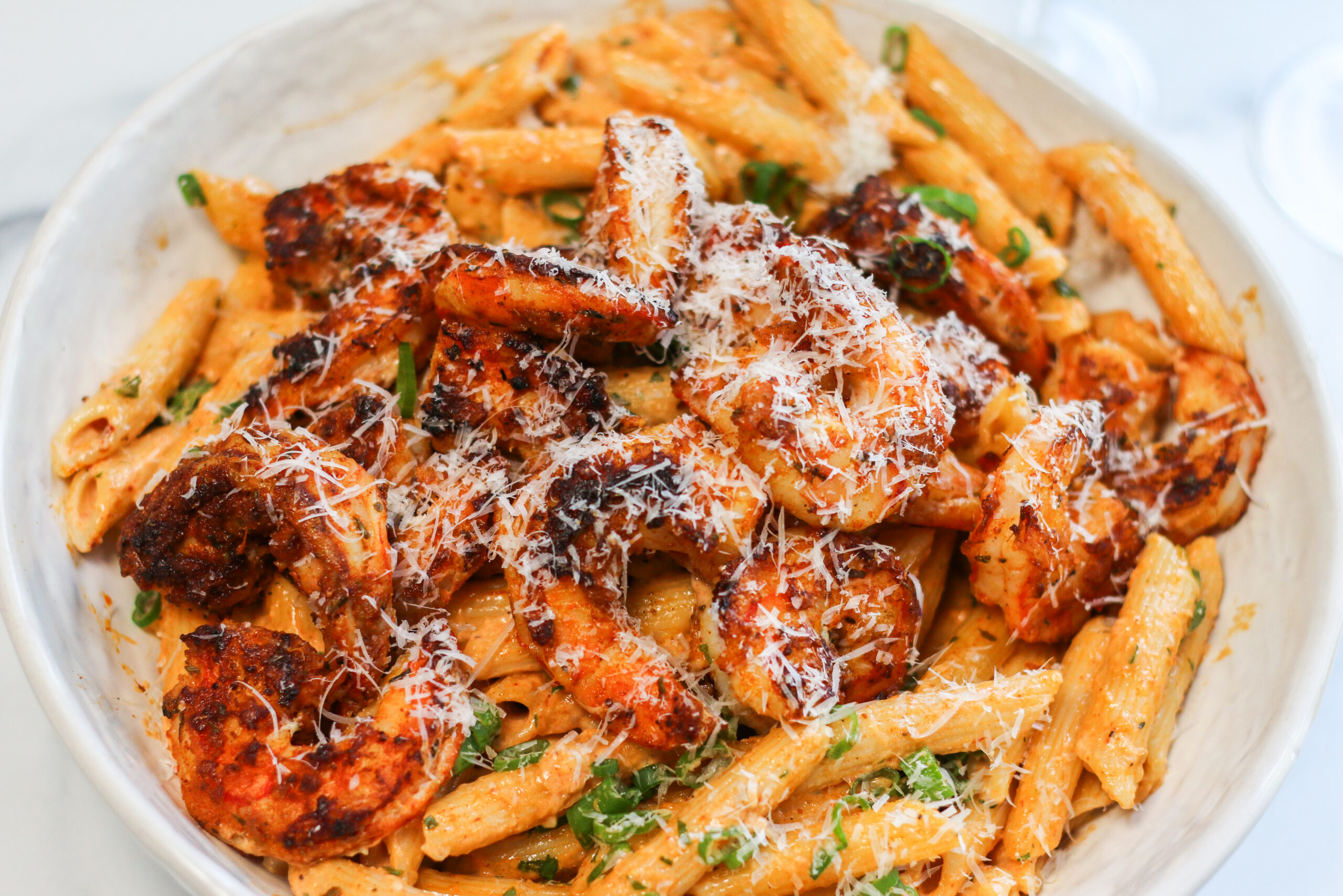 A plate of pasta with meat and cheese.