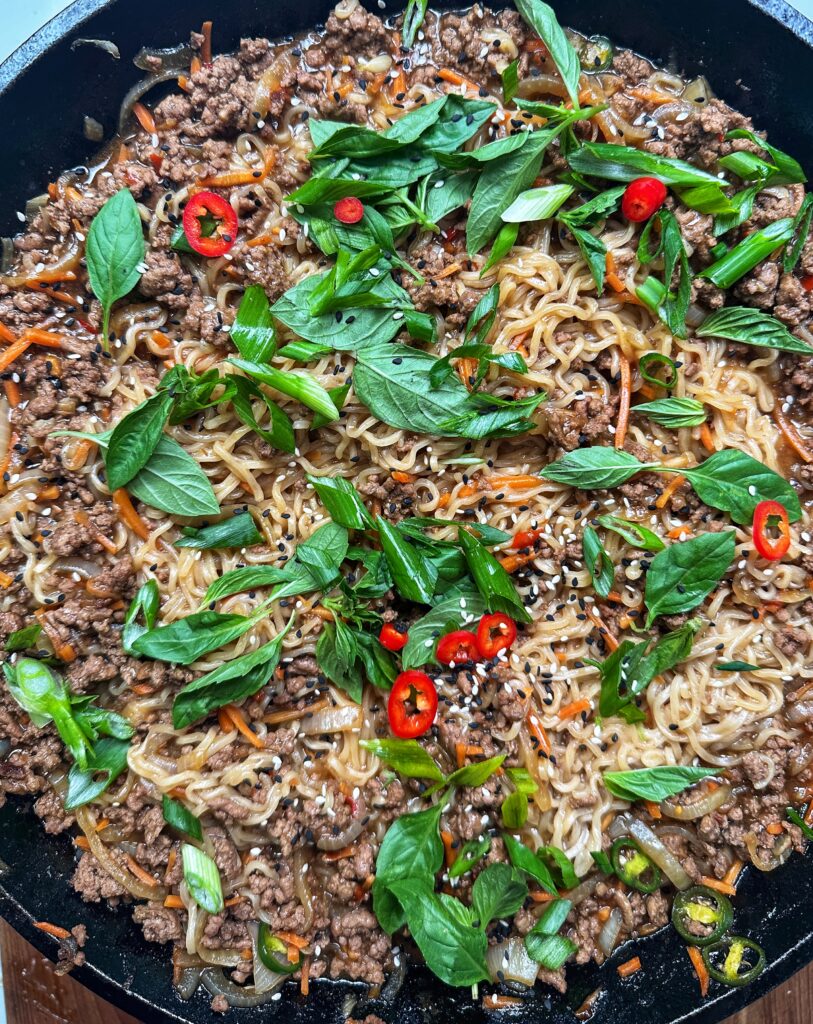 A close up of rice with meat and vegetables